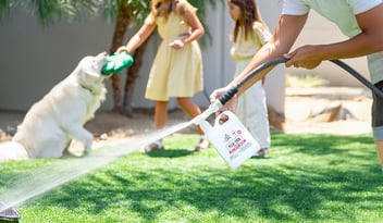 woman spraying yard with skout's honor flea and tick yard spray